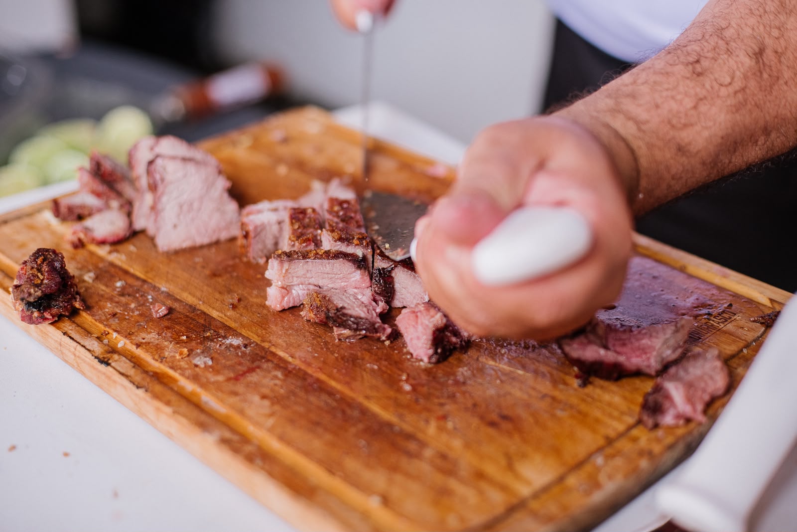 Carne assada sendo fatiada na tábua